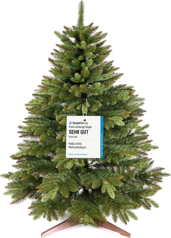 Groene kunstkerstboom met een keurmerk van 'Vergleich.org SEHR GUT'.