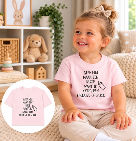 Roze T-shirt met tekst: Geef mij maar een kusje want ik krijg een broertje of zusje, gedragen door een glimlachend meisje.