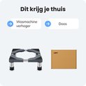 Zwarte verstelbare wasmachine verhoger met grijze poten en groene accenten, naast een bruine kartonnen doos met 'LUFT' erop.