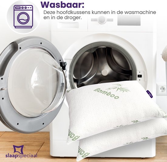 Twee witte kussens met bamboe print naast een openstaande wasmachine.