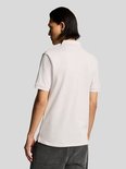 Man draagt lichtroze poloshirt, achterkant zichtbaar.