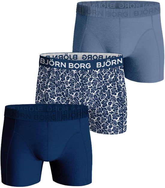Drie Björn Borg boxershorts: lichtblauw effen, donkerblauw effen en blauw met wit bladmotief.