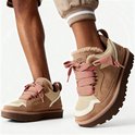 Bruine lage UGG sneakers met roze veters en suède overlays. Zichtbaar op blote benen.