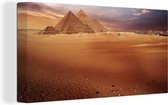 Canvas Schilderij De piramides van Giza in Egypte bij schemering - 40x20 cm - Wanddecoratie