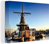 Canvas Schilderij Windmolen aan het water in Haarlem - 120x90 cm - Wanddecoratie