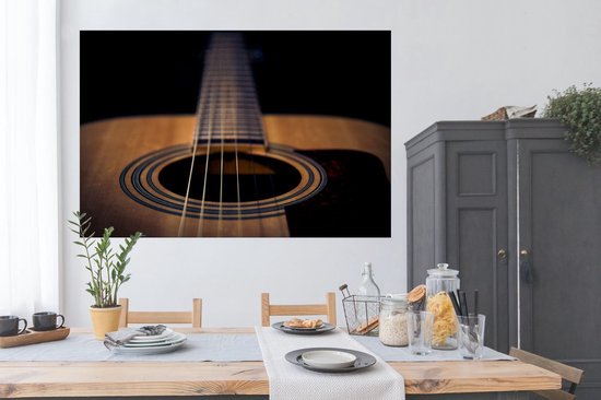 Poster Close up van een Akoestische gitaar op een zwarte achtergrond - 180x120 cm XXL