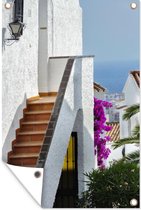 Tuinposter - Tuindoek - Tuinposters buiten - Een uitzicht op de zee tussen de witte huizen door Spanje - 80x120 cm - Tuin