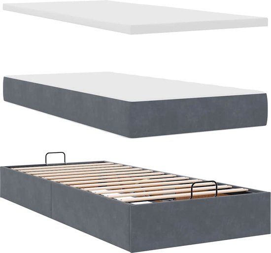Drie onderdelen van een bed: een witte topper, een donkergrijs matras, en een bedombouw met lattenbodem.