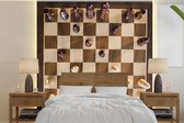 Behang - Fotobehang Een schaakbord vol met stukken - Breedte 350 cm x hoogte 350 cm