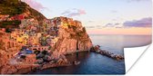 Poster Een oranje gekleurd Cinque Terre door de laagstaande zon in Italië - 150x75 cm