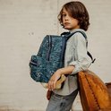 Jongen met een blauwe rugzak met tijgerprint, zandkleurige onderkant.