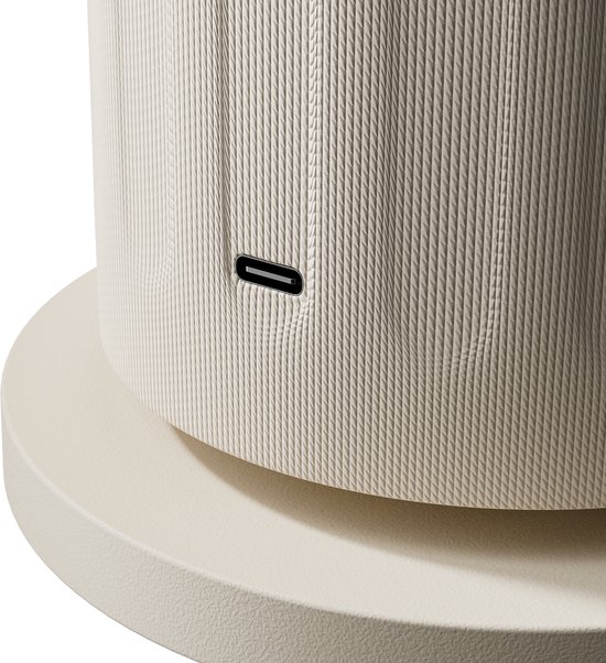 Close-up van de getextureerde zijkant van een beige diffuser met een USB-C poort.