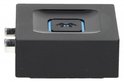Zwarte vierkante adapter met blauw Bluetooth-logo en zilveren RCA-uitgangen aan de zijkant.