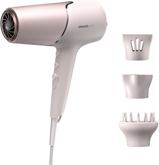 Witte Philips föhn met roze accenten en drie opzetstukken: diffuser, concentrator en volume.