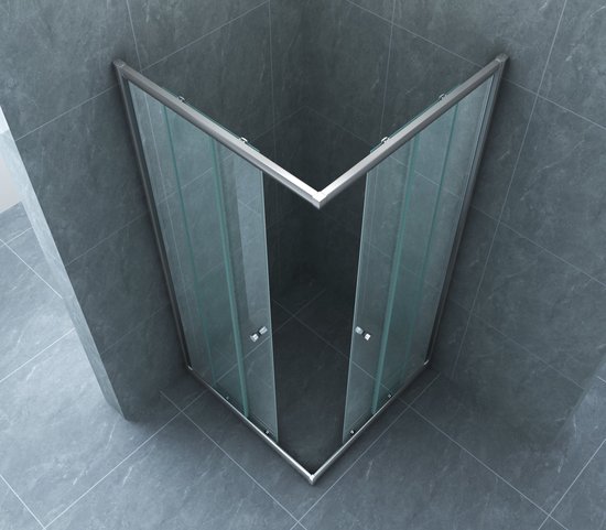 Cabine de douche avec entrée d'angle en V, verre transparent et profilés chromés.