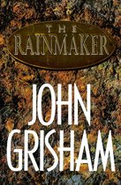 Boek "The Rainmaker" van John Grisham met een bronzen ovale titel op een roestbruine achtergrond.