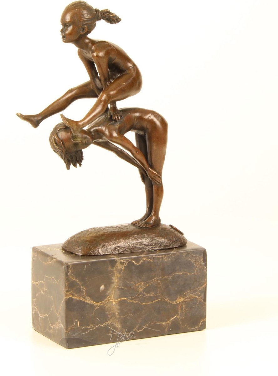 EEN BRONZEN BEELD MET 2 KINDEREN AAN HET BOKSPRINGEN