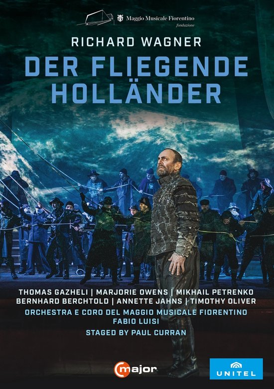 De Nederlandse dvd-hoes voor Der Fliegende Hollander toont een man op de voorgrond, omringd door een cast in scheepskleding. De titel is in grote, blauwe letters.