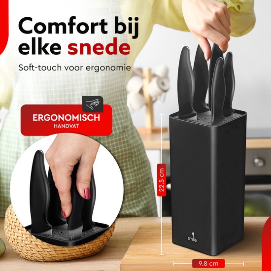 Femme avec tablier coupant avec un couteau de chef noir. Détail d'une main retirant un couteau du bloc.