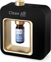 Zwarte aroma diffuser met gouden frame. Een flesje 'Mountain' is geplaatst in de diffuser.