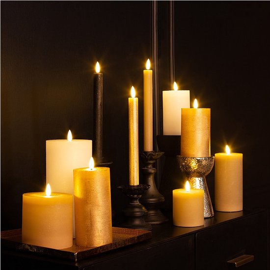 Een collectie van diverse LED kaarsen in verschillende maten en kleuren, waaronder goud en wit, op een dressoir.