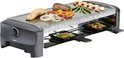 Raclette-grill met gegrilde zalm, steak, garnalen en groenten op de granieten plaat.