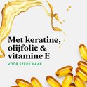 Gouden olie met capsules voor sterk haar.