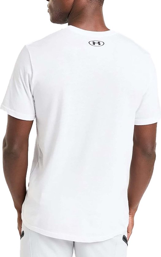 Man in een wit Under Armour shirt, achterkant met zwart logo op de nek.