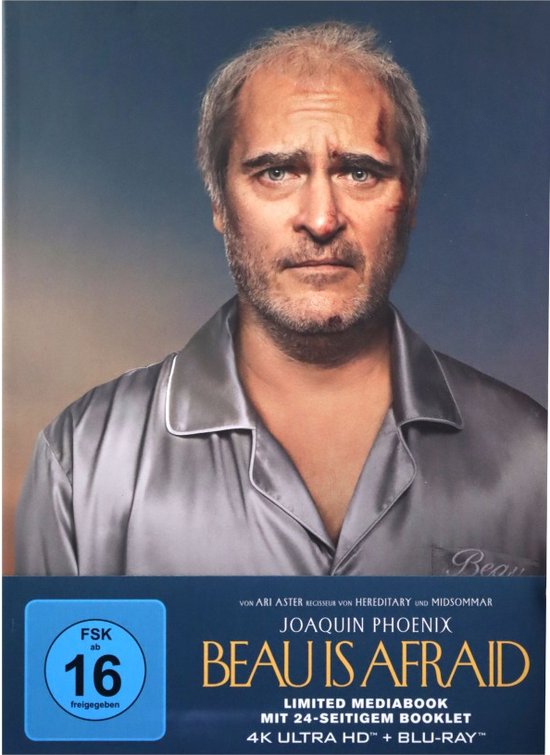 Voorzijde van de "Beau Is Afraid" mediabook met Joaquin Phoenix in een satijnen pyjama.