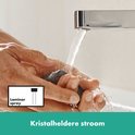 Hendel van chromen wastafelkraan met heldere waterstraal.