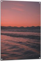 WallClassics - Tuinposter – Golvende Zee met Oranje Paarse Lucht - 80x120 cm Foto op Tuinposter (wanddecoratie voor buiten en binnen)