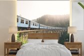 Behang - Fotobehang Een trein over een brug - Breedte 280 cm x hoogte 280 cm
