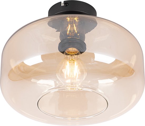 Een amberkleurige glazen plafondlamp met een zwarte basis.