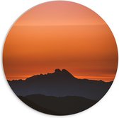 WallClassics - PVC Schuimplaat Muurcirkel - Silhouette van Bergen bij Zonsondergang - 70x70 cm Foto op Muurcirkel (met ophangsysteem)