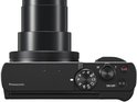 Bovenaanzicht van een zwarte Panasonic Lumix compactcamera met de lens uitgeschoven en draaischijf.