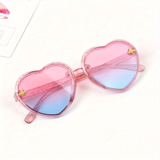 Roze hartvormige zonnebril met glittermontuur en roze-blauwe glazen.