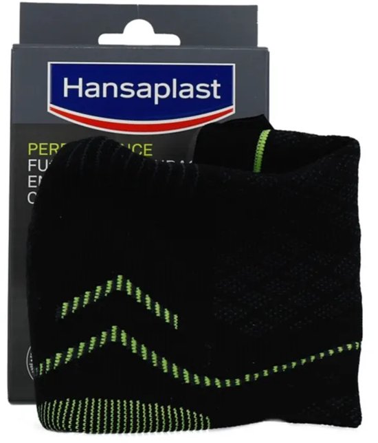 Zwarte sport enkelbrace met groene accenten, naast de verpakking.