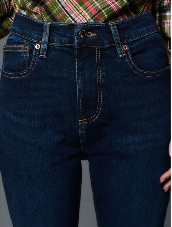 Dames met donkerblauwe jeans met ritssluiting en knoopsluiting.