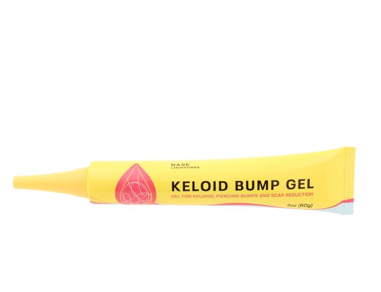 Gele tube met blauwe opdruk 'KELOID BUMP GEL' en cirkelvormig roze en geel logo.