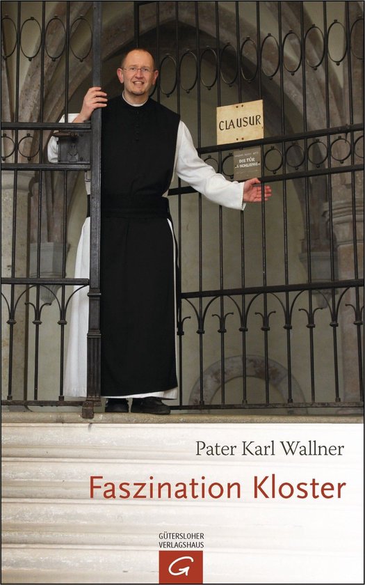 Père Karl Wallner en habit de moine noir et blanc devant une grille avec un panneau 'CLAUSUR'.