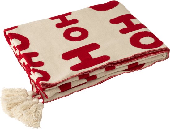 Gebreide off-white deken met rode "HO HO HO" tekst en off-white kwastjes.