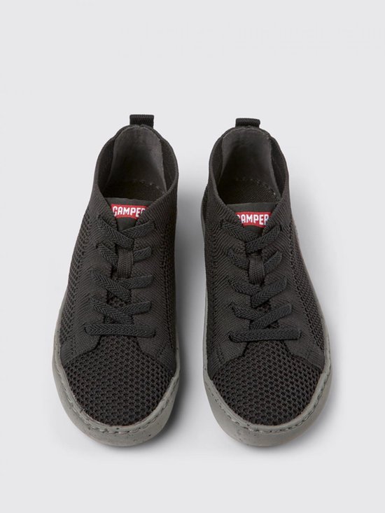 Zwarte gebreide lage sneakers met veters en grijze zool.