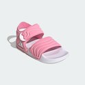 Roze Adilette sandalen voor kinderen met witte zool, klittenband en geribbelde banden.