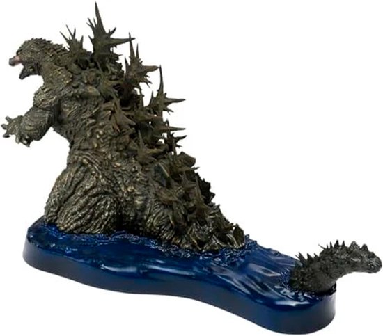 Godzilla figuur met scherpe rugplaten, op een blauwe waterbasis.