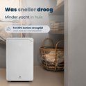 Witte Vibrix luchtontvochtiger met display '42' in een wasruimte met manden en handdoeken. Text: 'Was sneller droog. Minder vocht in huis.'