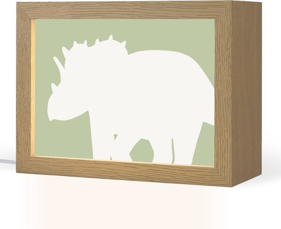 Houten tafellamp met groene achtergrond en witte dinosaurusprint.