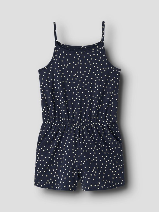 Donkerblauwe jumpsuit met beige stippen, spaghetti bandjes en elastische taille, op grijze achtergrond.