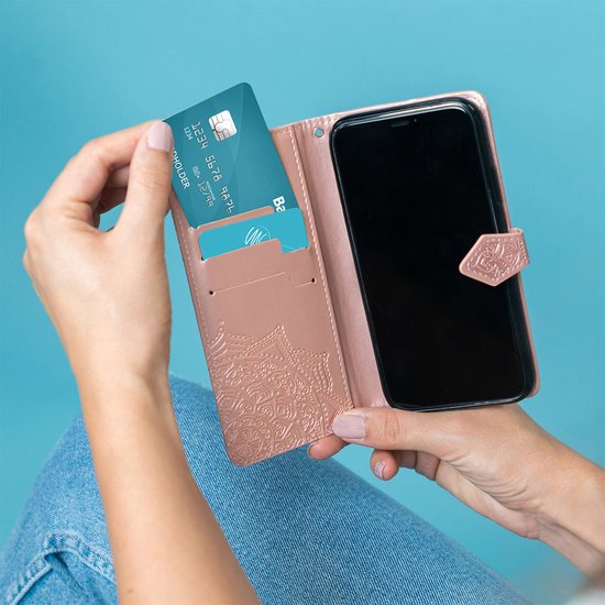 Een rosé gouden telefoonhoesje met mandela-reliëf, met vakjes voor pasjes en een bankpas erin.