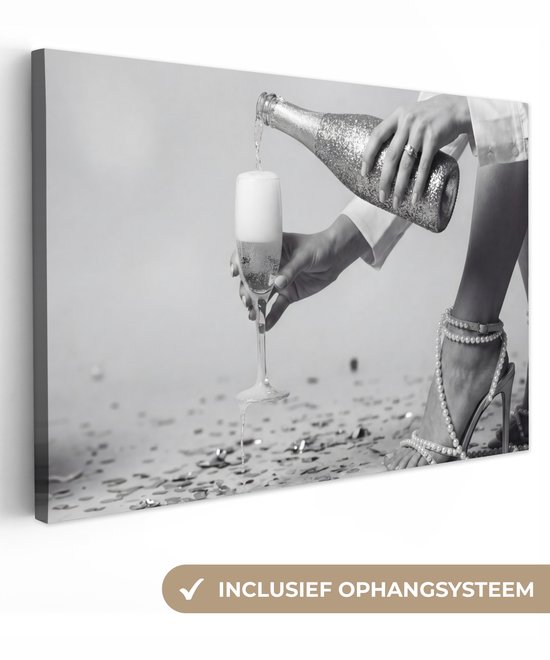 Zwart-wit canvas van een schenkend champagneglas, inclusief ophangsysteem.