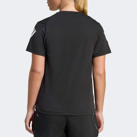 Achterkant van een vrouw in een zwart sportshirt met de kenmerkende Adidas strepen.